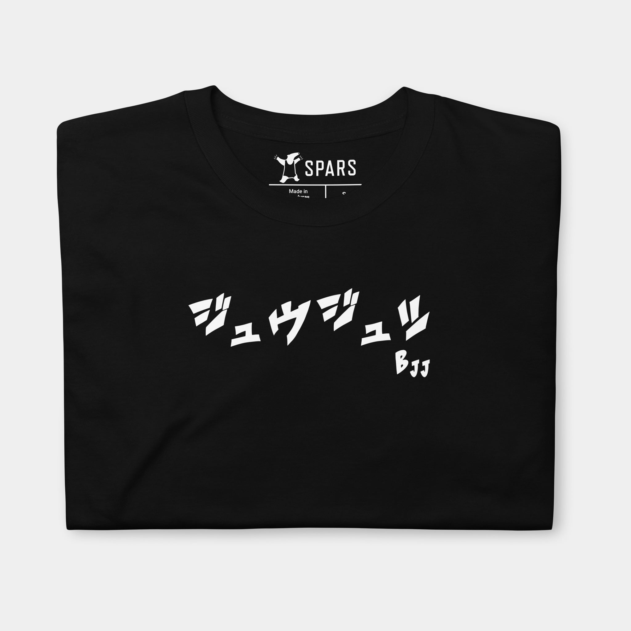 Folded Men’s BJJ KATAKANA Daily Tee in Black showing the white BJJ katakana chest design