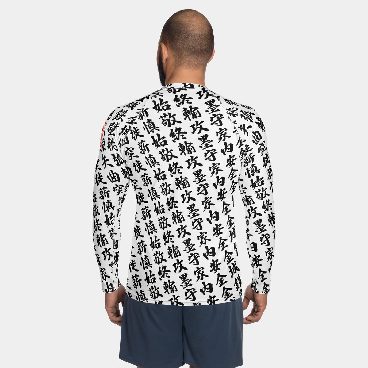 Back view of the men's TOO MUCH KANJI long-sleeve BJJ rash guard in White and Black on a model