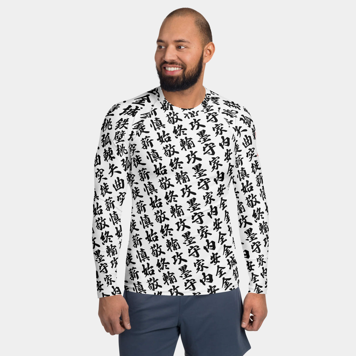 Front view of the men's TOO MUCH KANJI long-sleeve BJJ rash guard in White and  Black on a model