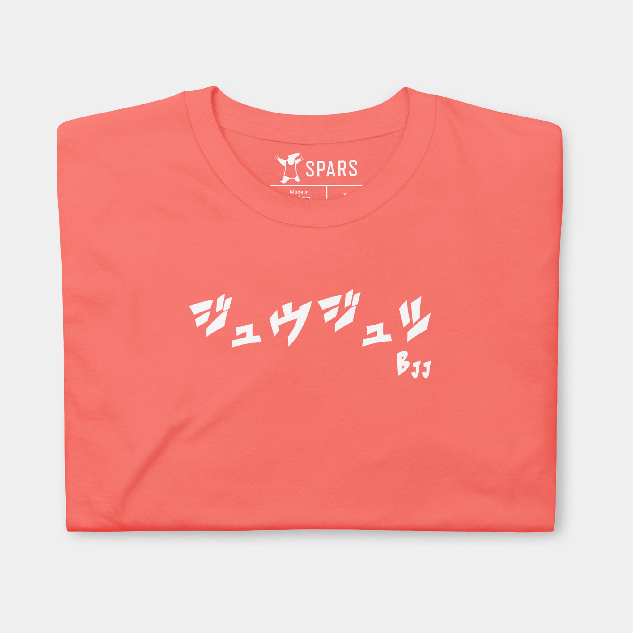 Folded Women’s BJJ KATAKANA Daily Tee in Coral Silk showing the white BJJ katakana chest design