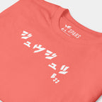Close-up of the white BJJ katakana chest design on the Women’s BJJ KATAKANA Daily Tee in Coral Silk