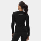 Woman wearing the Women’s BJJ KATAKANA Long-Sleeve Rash Guard in Iron Black, back view with off-white SPARS upper-back logo