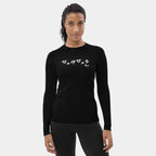 Woman wearing the Women’s BJJ KATAKANA Long-Sleeve Rash Guard in Iron Black, full front view showing the off-white katakana and BJJ chest print